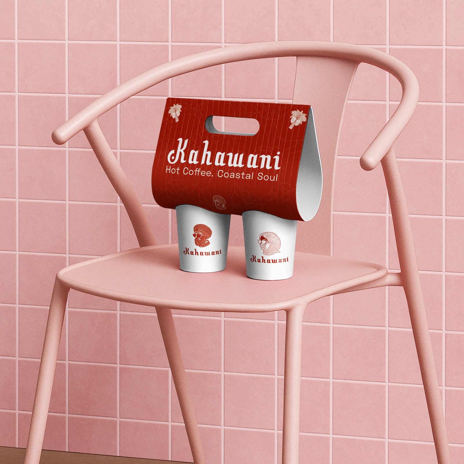 Red Kahawani cup carrier reading Hot Coffee. Coastal Soul, holding two white cups with the portrait mark, on a pink chair against pink tiles.