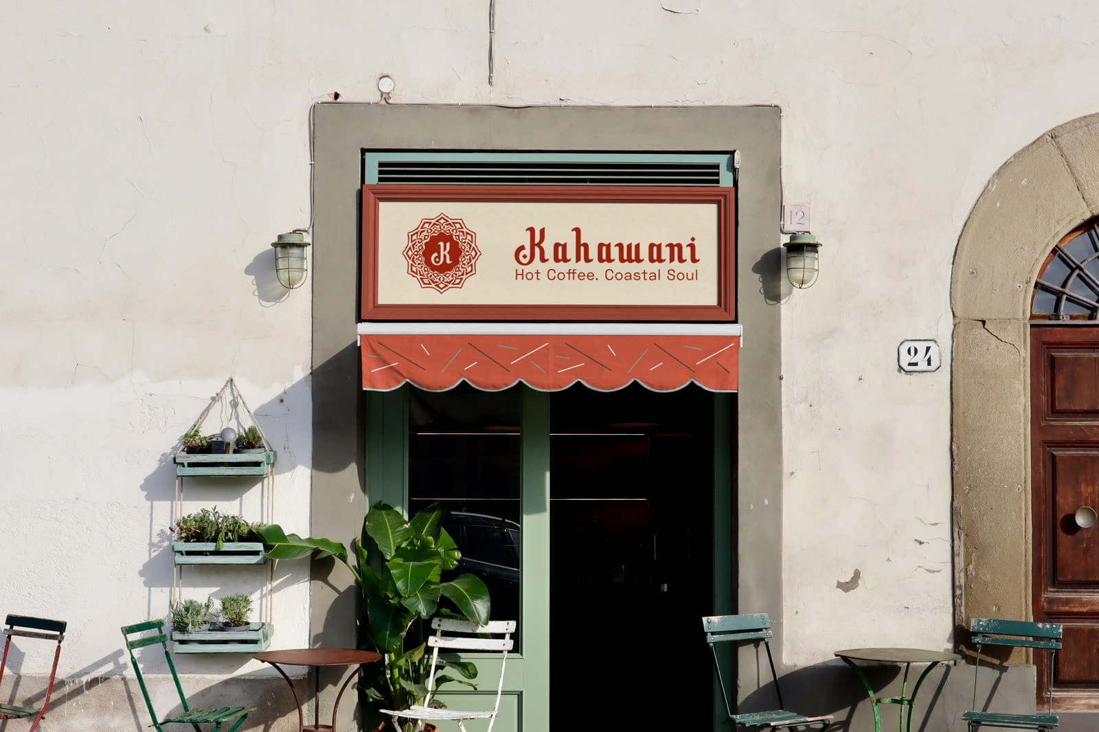 Cafe storefront with a cream Kahawani sign, ornamental K monogram, tagline Hot Coffee. Coastal Soul, and a terracotta awning.